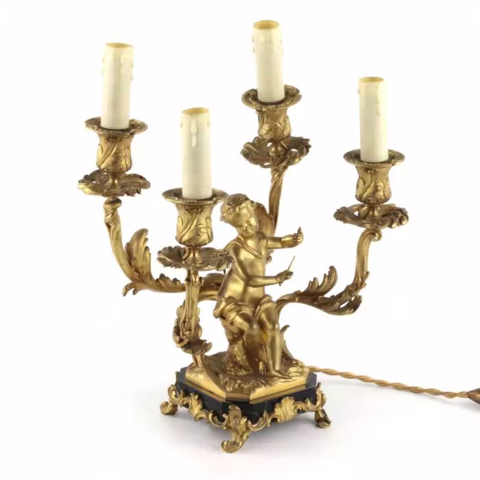 Paired lamps of gilded bronze with cupids playing music. 