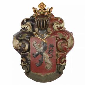 Large, carved, wooden coat of arms depicting a knight`s helmet topped with a crown. 19th century. 